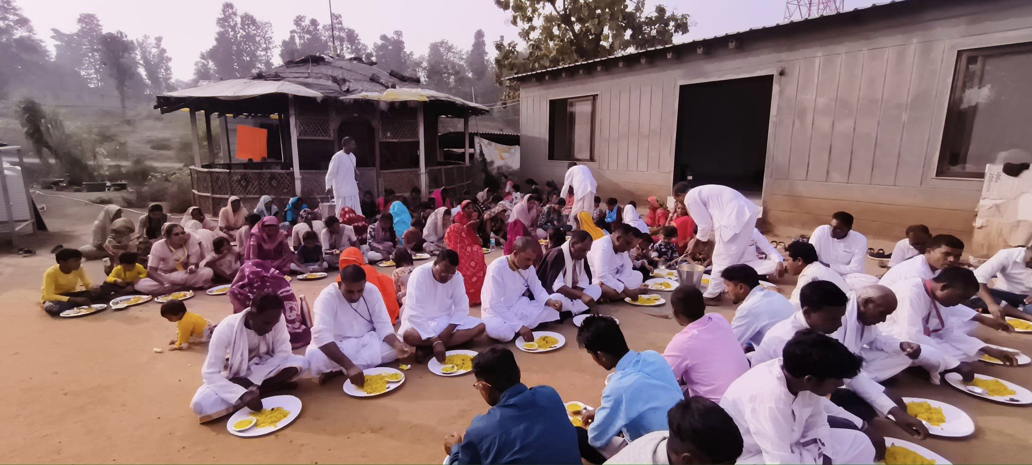 Devotees serving prasadam to villagers.
